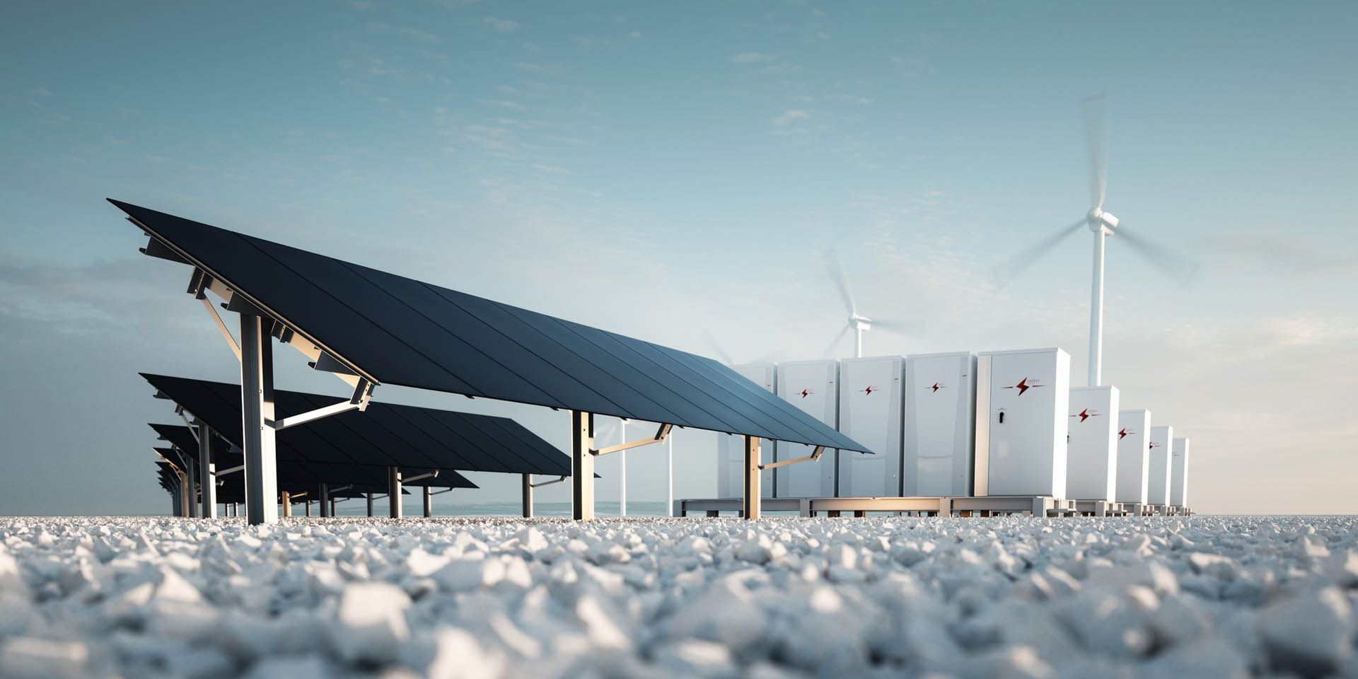Solar panels, wind turbines, and energy storage units in a snowy landscape.