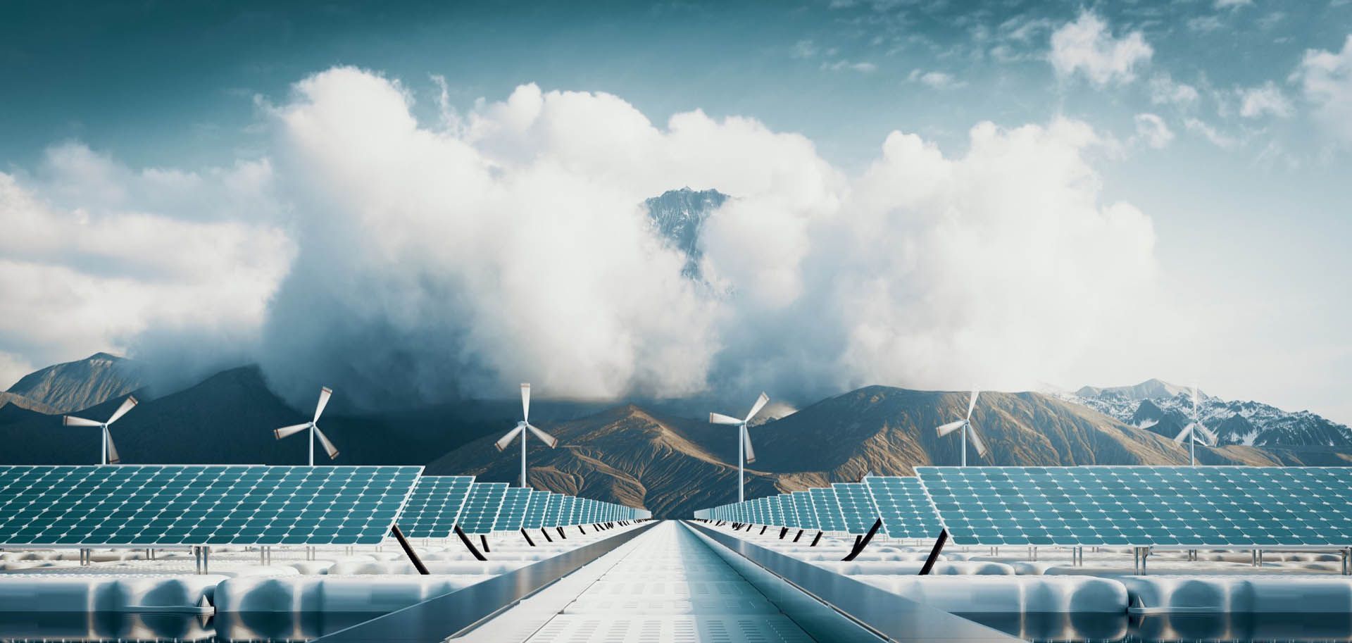 Solar panels and wind turbines with mountains and clouds in the background, a nature landscape.