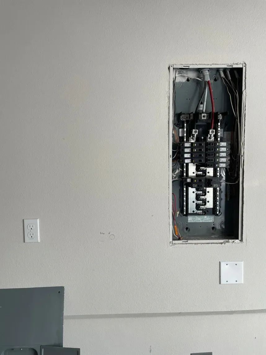 Kitchen with blue cabinets, pendant lights, a skylight, and stainless steel appliances.