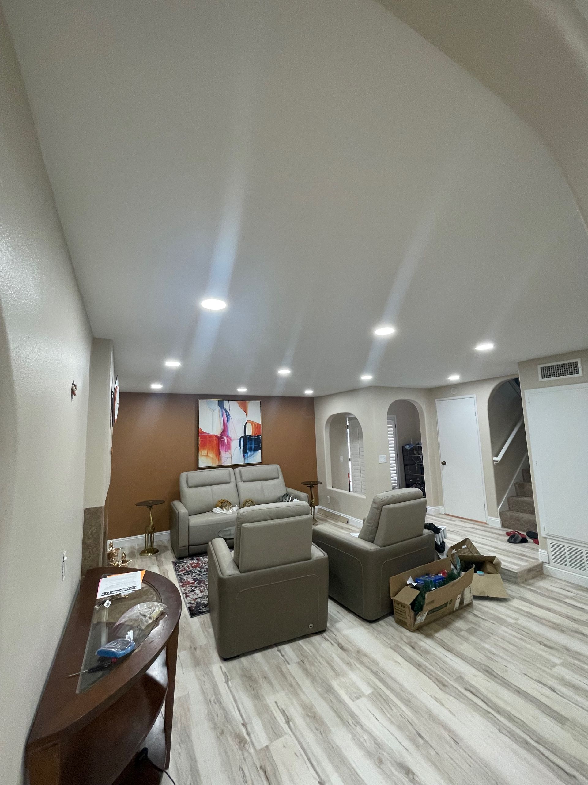 Kitchen with wood cabinets, microwave, and stove. Beige backsplash, counter with items.