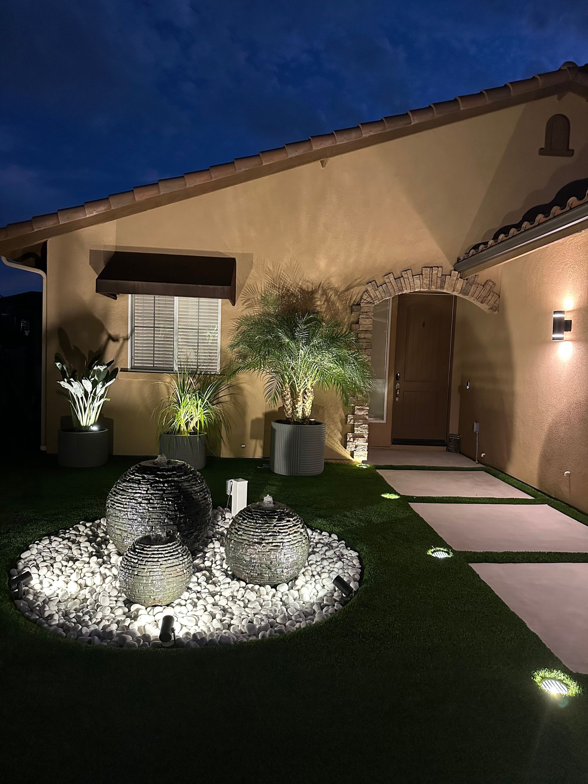 Kitchen with white cabinets, pendant lights, and ladder.