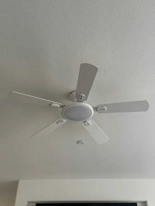 White ceiling fan with five blades and a central light fixture.