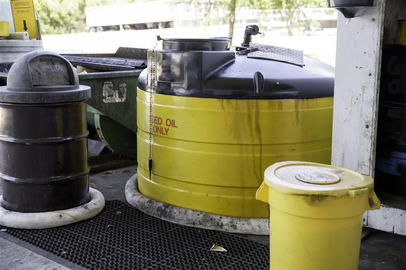 Black and yellow container for used motor oil representing waste oil collection in Denver, CO, by De