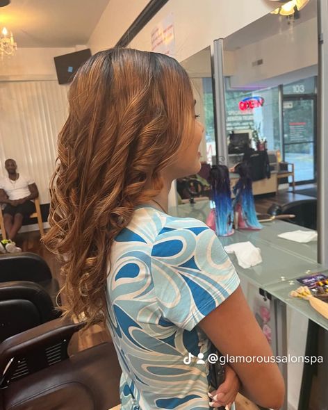 A woman is getting her hair done in a salon.