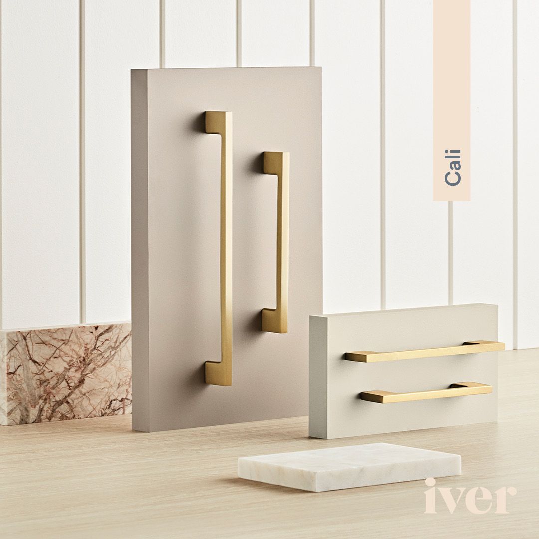 A Collection Of Brass Cabinet Handles Are Sitting On A Wooden Table — Port Macquarie Locksmiths In Port Macquarie, NSW