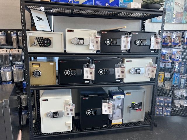 A Display Of Safes On A Shelf In A Store — Port Macquarie Locksmiths In Port Macquarie, NSW