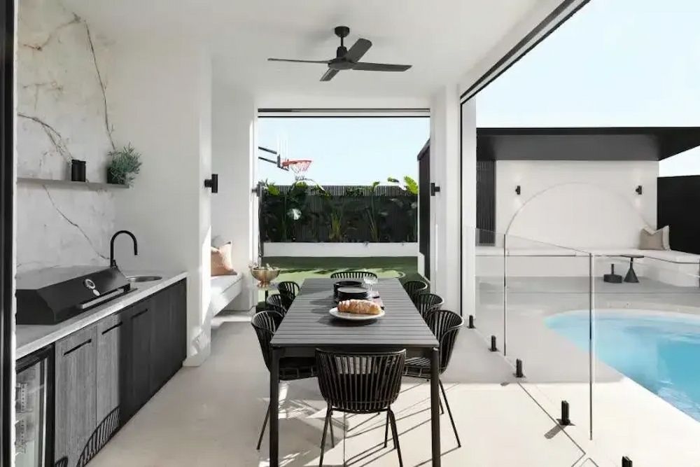 A Dining Room With a Table and Chairs Next to a Pool — Aussie UnderCover In South Nowra, NSW