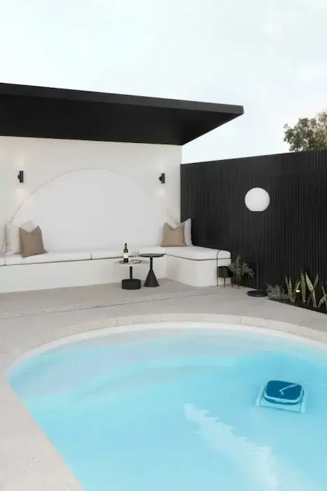 There Is A Swimming Pool In The Backyard Of A House With A Black Fence — Aussie UnderCover In South Nowra, NSW