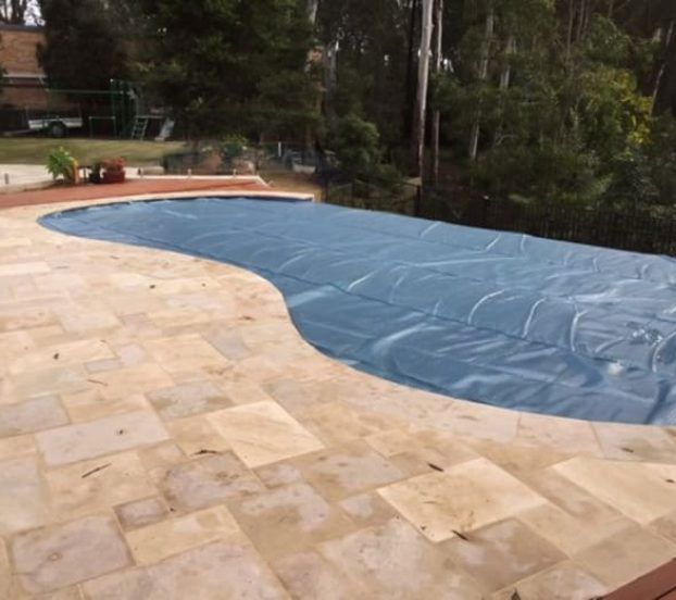 A Swimming Pool With a Blue Cover on It — Aussie UnderCover In South Nowra, NSW