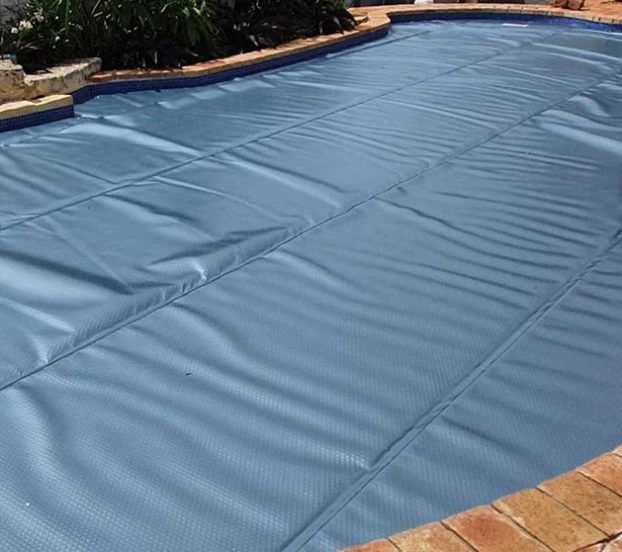 A Swimming Pool With a Blue Cover on It — Aussie UnderCover In South Nowra, NSW