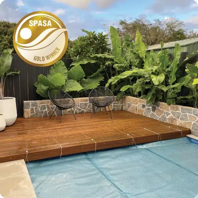 Two Chairs Are Sitting On A Wooden Deck Next To A Swimming Pool — Aussie UnderCover In South Nowra, NSW