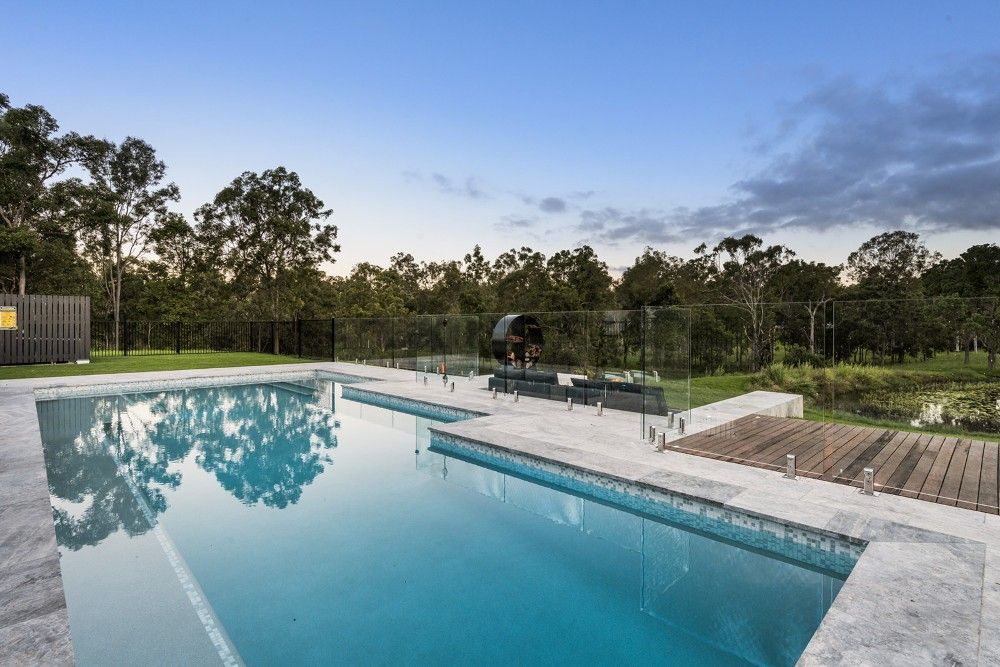 Pool With Clear Water, Surrounded by a Stone Border and Green Grass — Aussie UnderCover In South Nowra, NSW