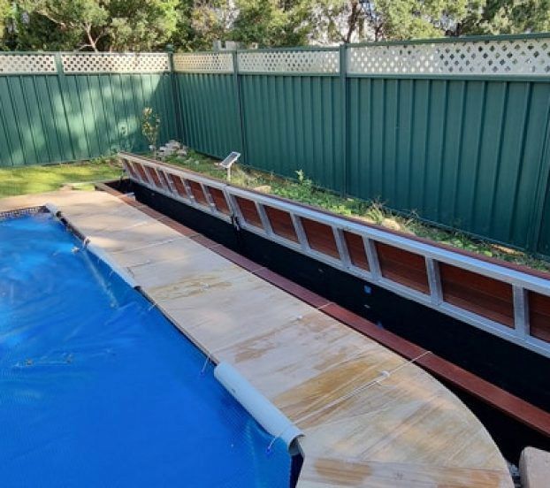 A Swimming Pool With a Blue Cover and a Green Fence — Aussie UnderCover In South Nowra, NSW