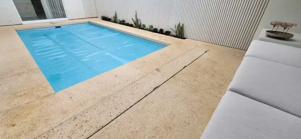A Large Swimming Pool Is Surrounded By A White Wall — Aussie UnderCover In South Nowra, NSW