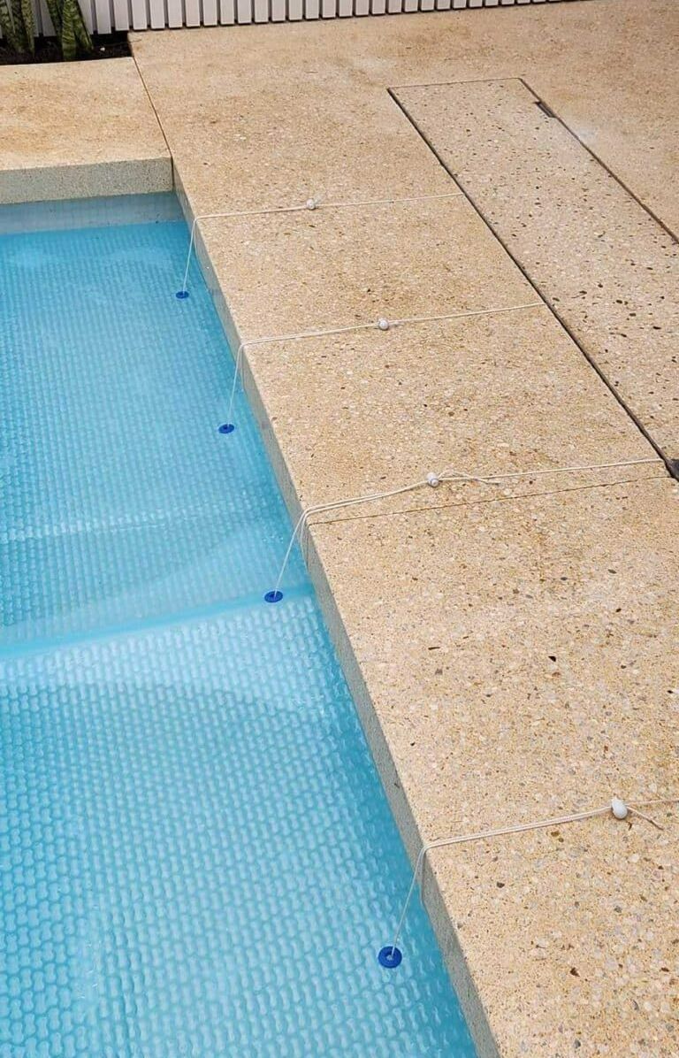 A Close Up Of A Swimming Pool With Blue Tiles And Steps — Aussie UnderCover In Northern Beaches, NSW