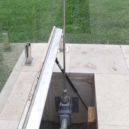 A Metal Pipe is Sitting in a Hole in the Ground Next to a Glass Railing — Aussie UnderCover In South Nowra, NSW