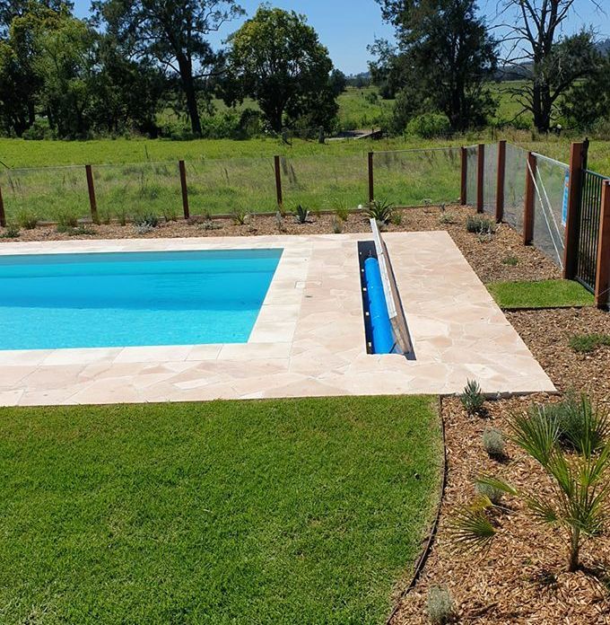 A Large Swimming Pool Surrounded by Grass and Trees — Aussie UnderCover In South Nowra, NSW