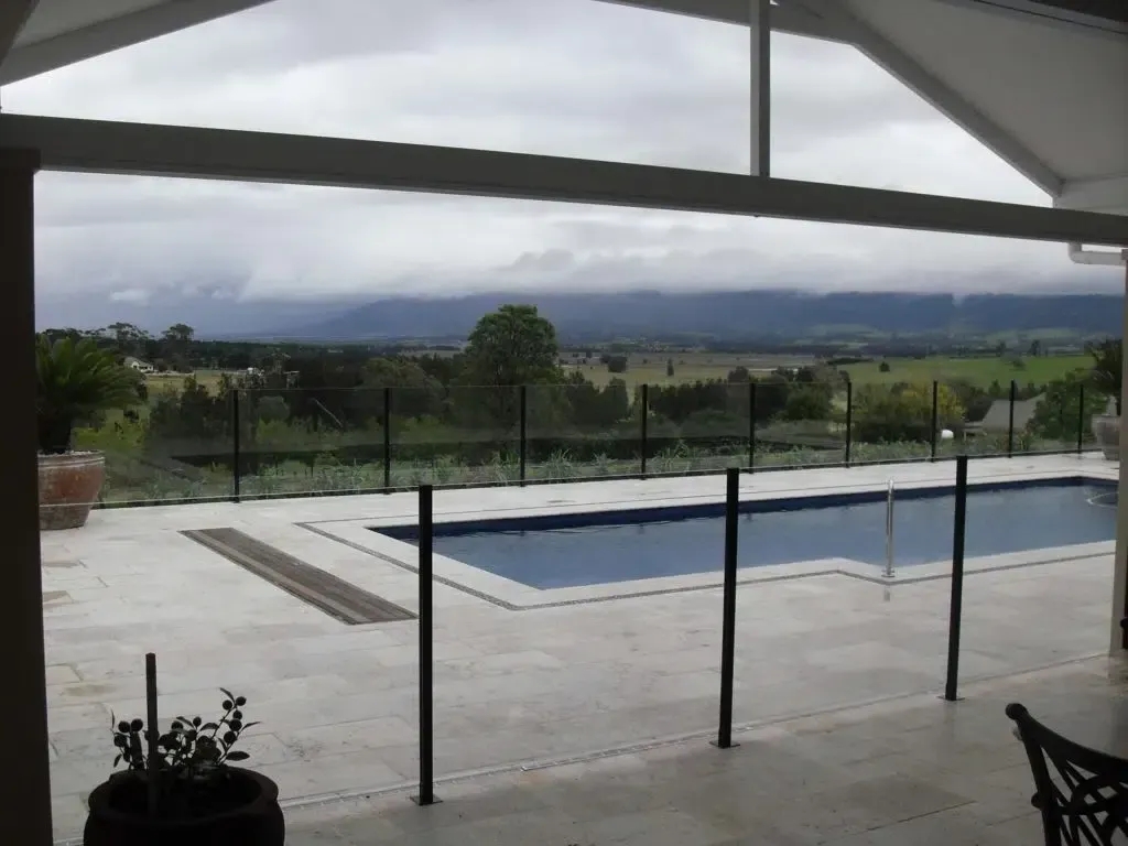 A View Of A Swimming Pool With Mountains In The Background — Aussie UnderCover In South Nowra, NSW
