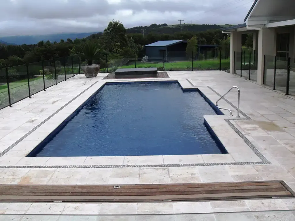 A Large Swimming Pool With A Fence Around It — Aussie UnderCover In South Nowra, NSW