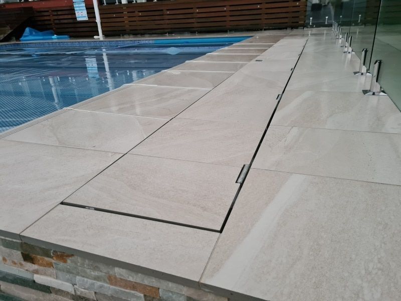 A Large Swimming Pool Is Sitting On Top Of A Wooden Deck — Aussie UnderCover In Mornington Peninsula, VIC