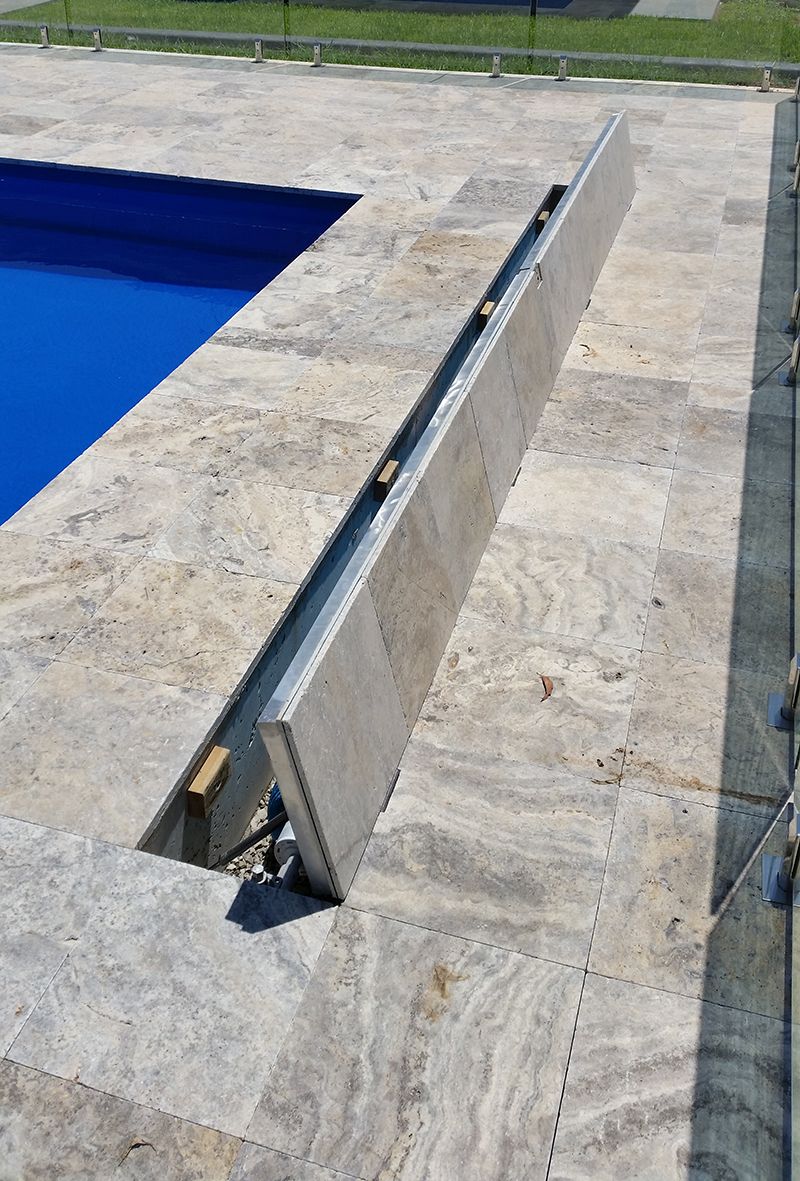 A Swimming Pool With A Stone Border And A Metal Barrier — Aussie UnderCover In Melbourne, VIC