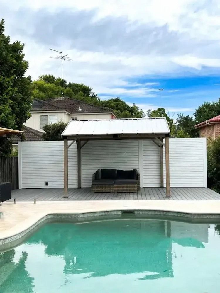 There is a Swimming Pool in the Backyard With a Pergola and a Couch — Aussie UnderCover In South Nowra, NSW