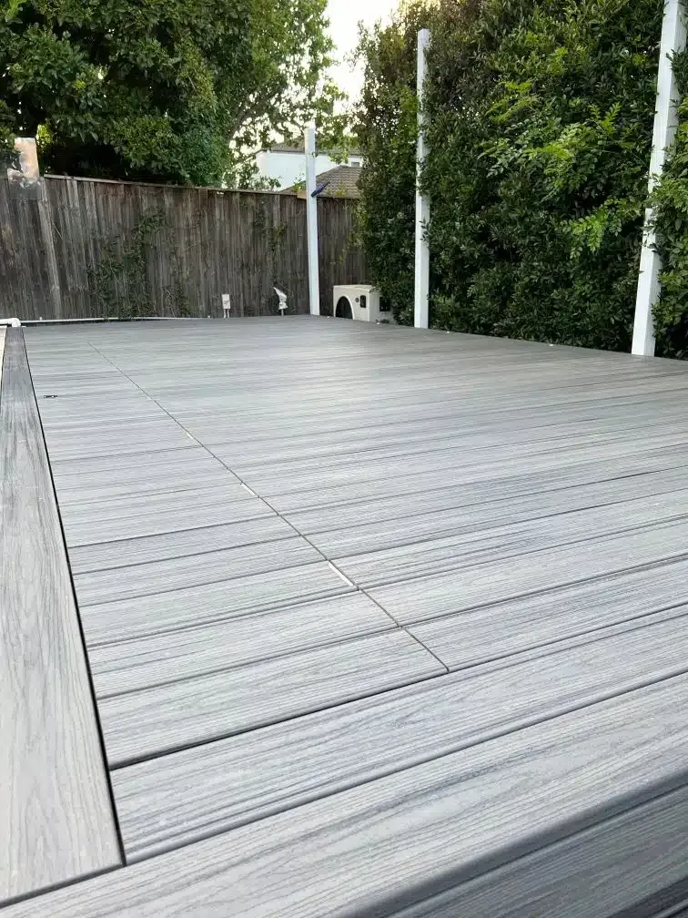 A Wooden Deck With A Fence In The Background And Trees In The Background — Aussie UnderCover In South Nowra, NSW