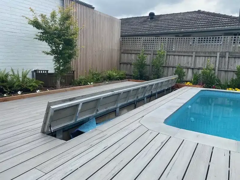 A Swimming Pool Is Surrounded By A Wooden Deck And A Fence — Aussie UnderCover In South Nowra, NSW