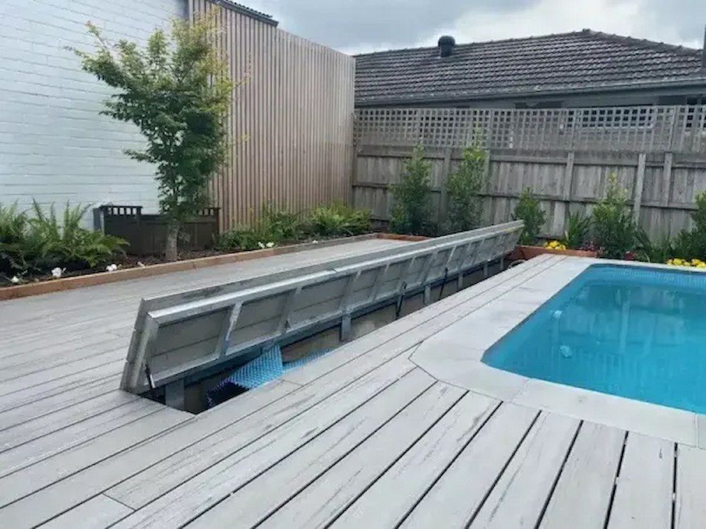 A Large Swimming Pool is Surrounded by a Wooden Deck — Aussie UnderCover In South Nowra, NSW