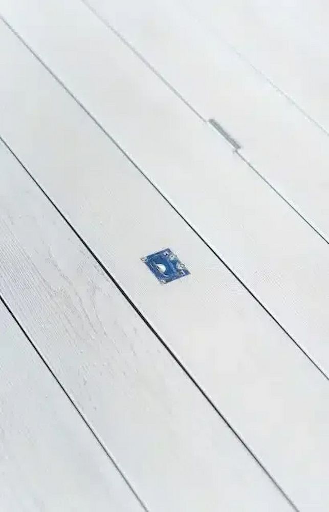 A Close Up of a White Wooden Floor With a Blue Square in the Middle — Aussie UnderCover In South Nowra, NSW
