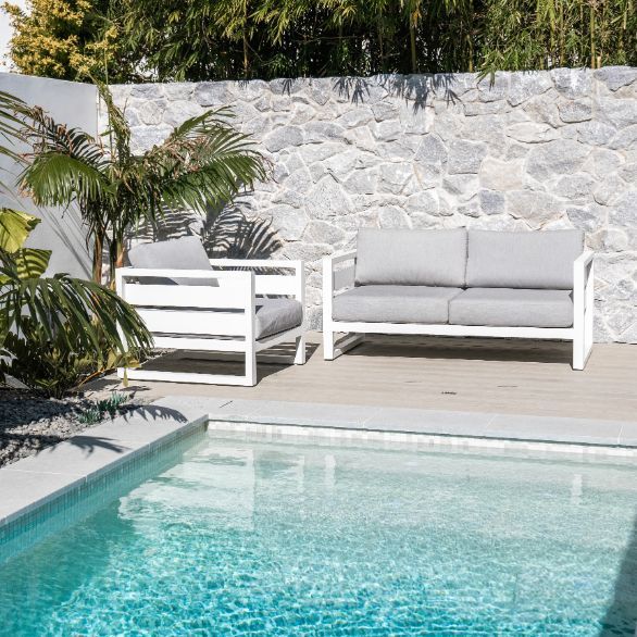 A Swimming Pool With a Couch and Chairs Next to It — Aussie UnderCover In South Nowra, NSW
