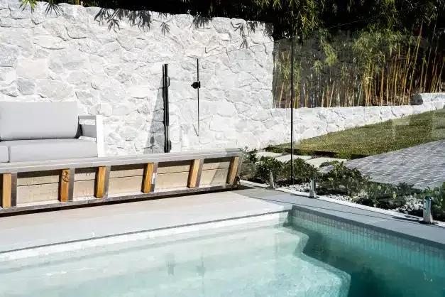 A Swimming Pool With A Bench And A Couch Next To It — Aussie UnderCover In South Nowra, NSW