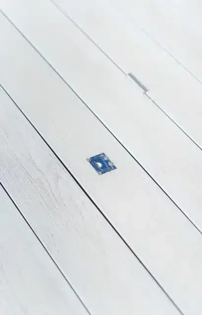 A Close Up Of A White Wooden Floor With A Blue Square On It — Aussie UnderCover In South Nowra, NSW