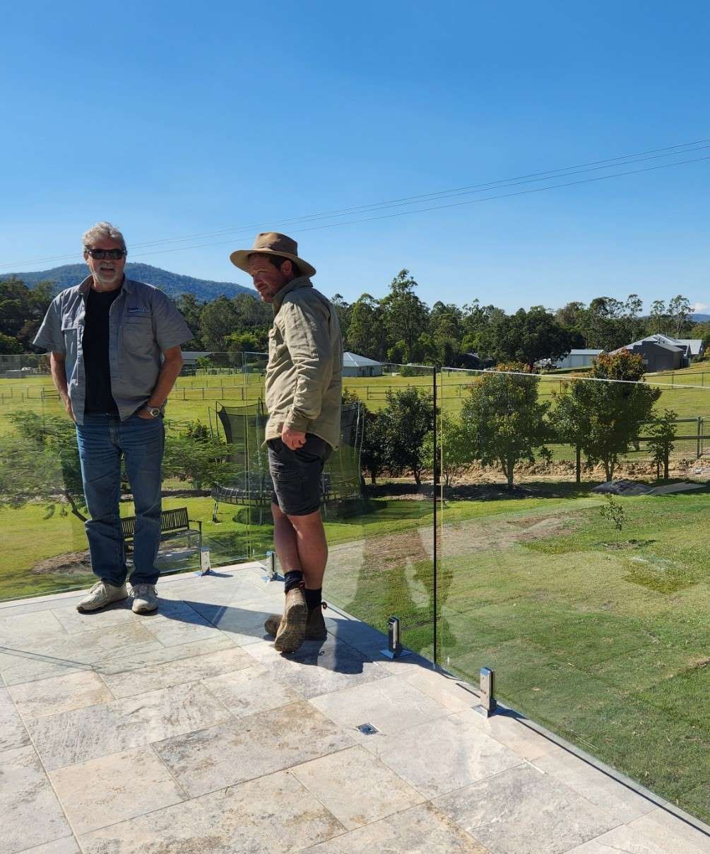 Two Men Are Standing On A Balcony Overlooking A Field — Aussie UnderCover In South Nowra, NSW