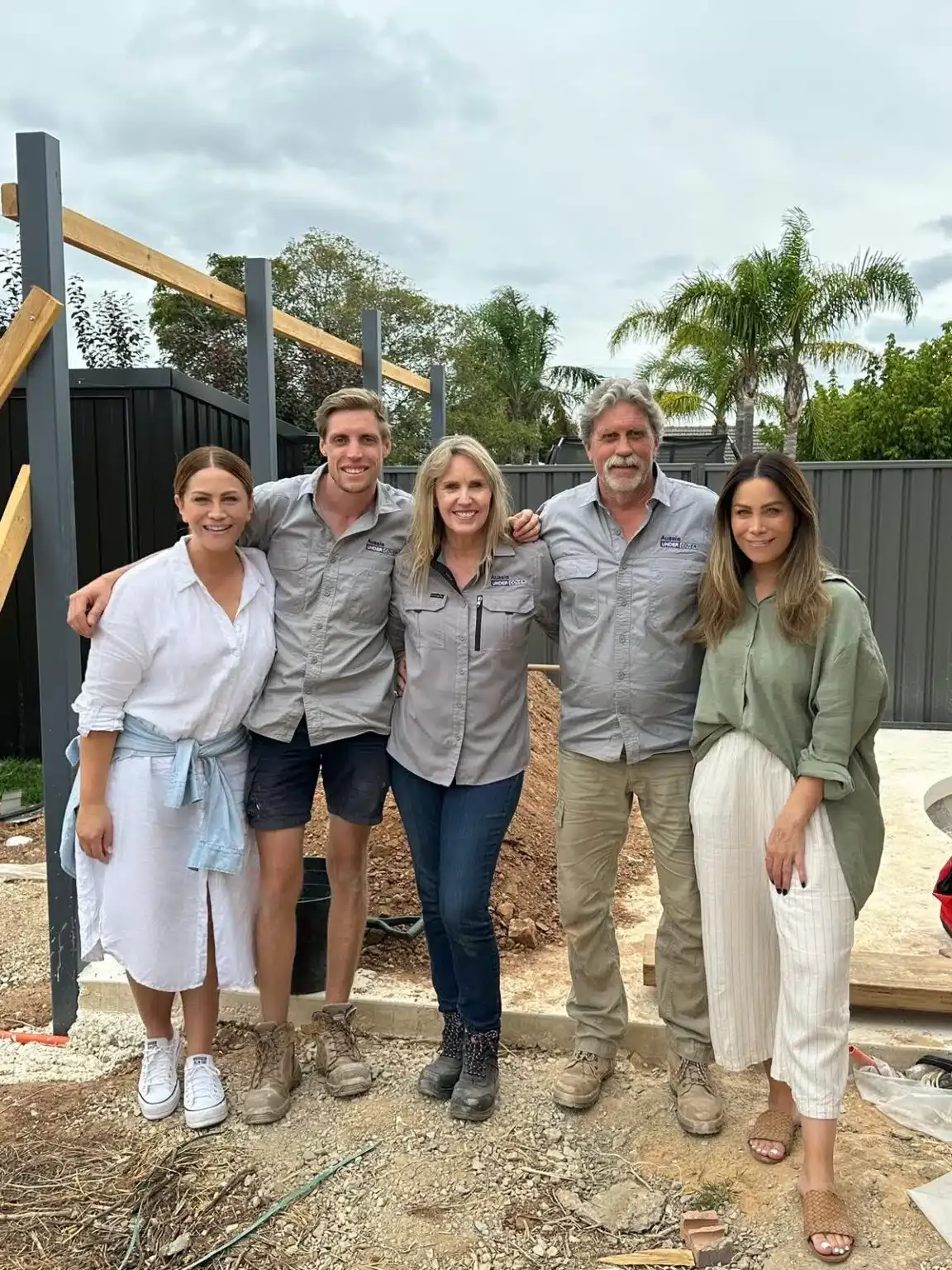 A Group Of People Standing Next To Each Other On A Construction Site — Aussie UnderCover In South Nowra, NSW