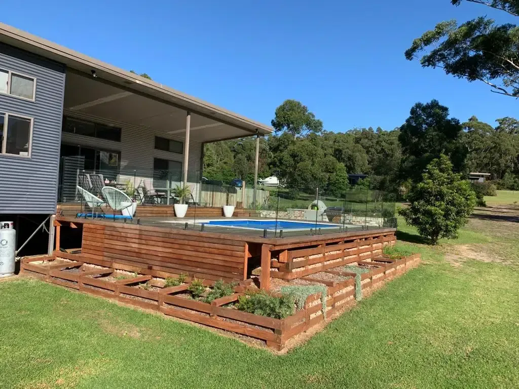 A Large House With A Large Swimming Pool In Front Of It — Aussie UnderCover In South Nowra, NSW