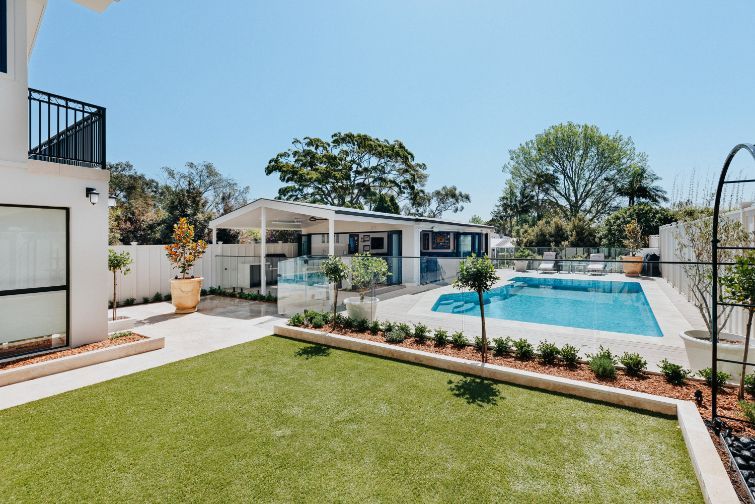 A White Fence Surrounds a Swimming Pool in a Backyard — Aussie UnderCover In South Nowra, NSW