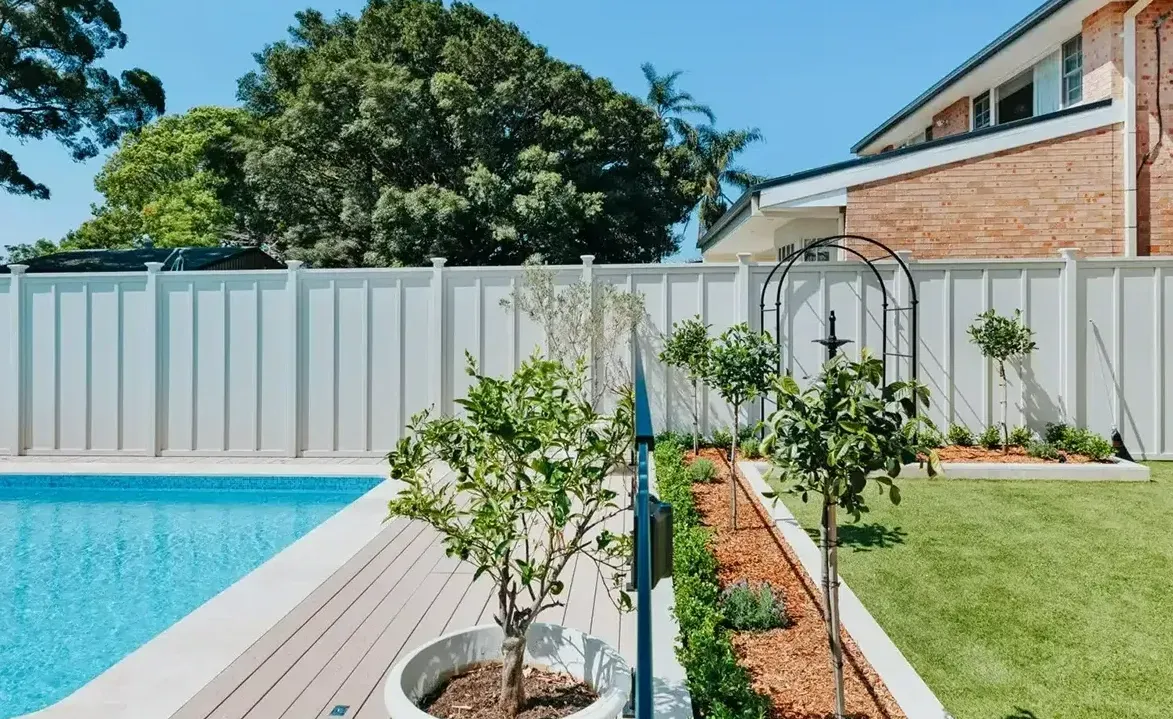 A White Fence Surrounds A Swimming Pool In A Backyard — Aussie UnderCover In South Nowra, NSW