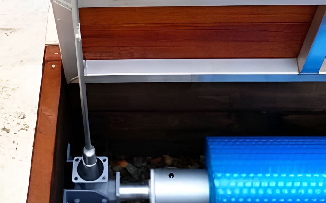 Pool Cover Mechanism With Blue Roller, Metal Cable, and Wood Paneling — Aussie UnderCover In Sydney, NSW