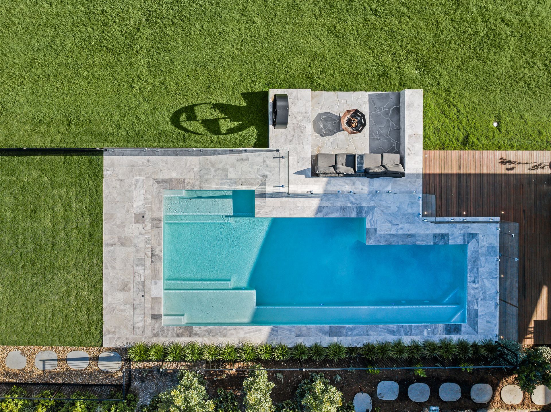 Two Chairs Are Sitting On A Wooden Deck Next To A Swimming Pool — Aussie UnderCover In South Nowra, NSW
