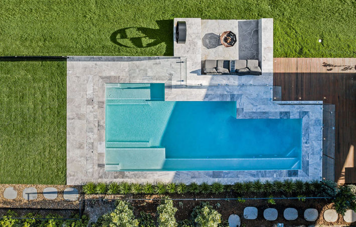 Overhead View of a Rectangular Pool With a Built-in Step, Surrounded by Stone Patio  — Aussie UnderCover In South Nowra, NSW
