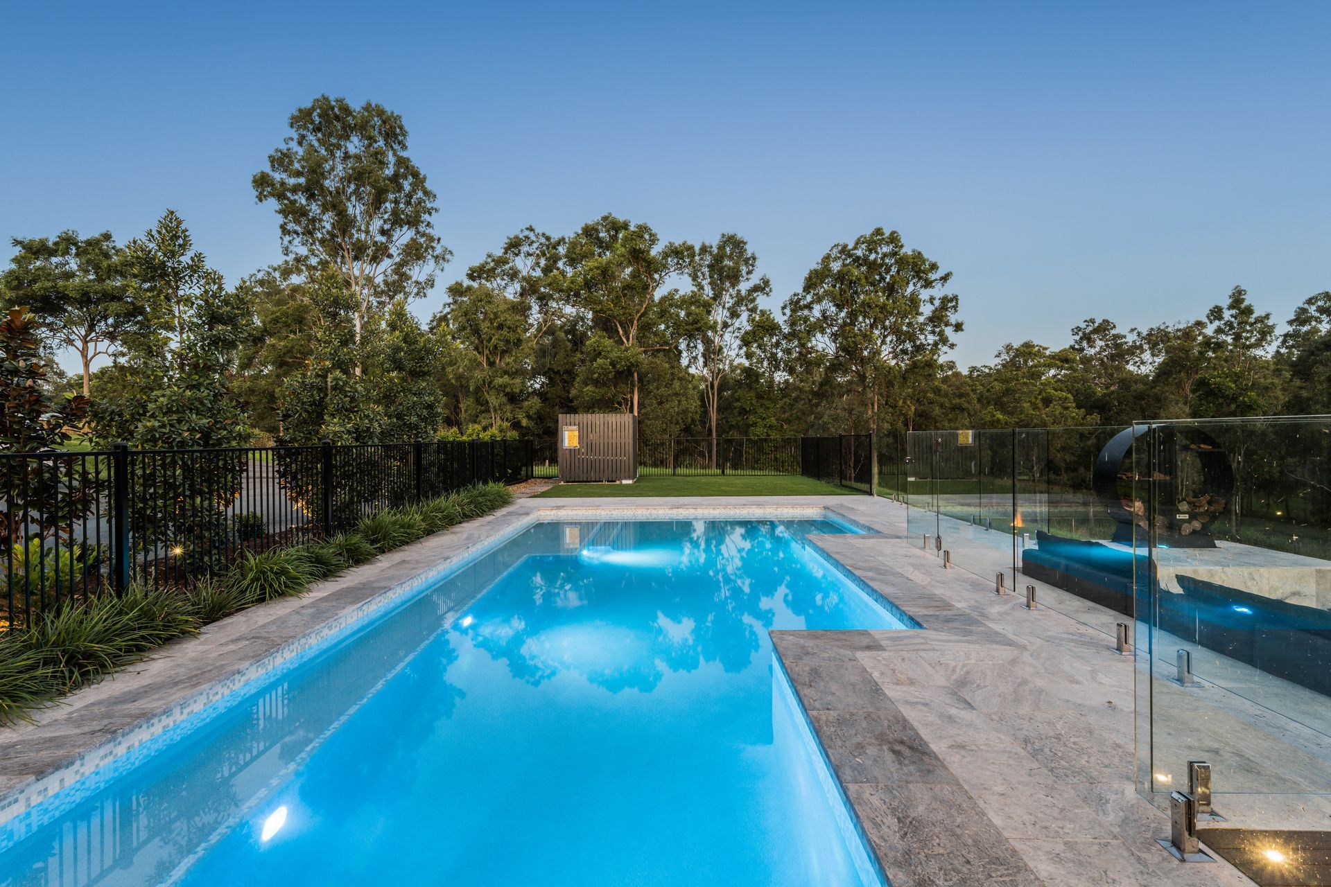 There Is A Swimming Pool In The Backyard Of A House With A Black Fence — Aussie UnderCover In South Nowra, NSW