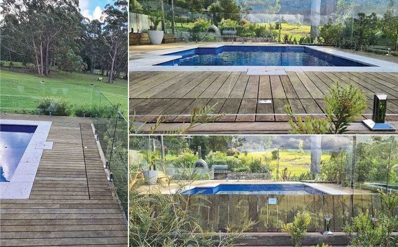 A Swimming Pool With A Wooden Deck In Front Of It — Aussie UnderCover In South Nowra, NSW