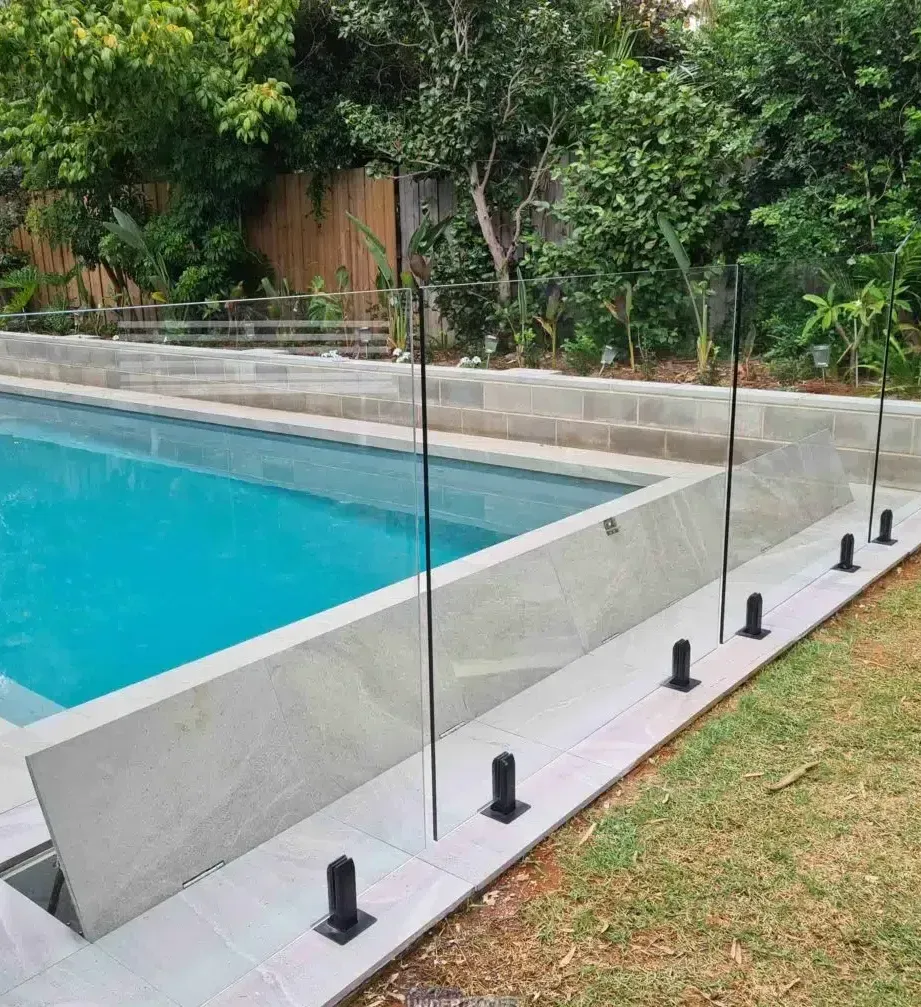 A Large Swimming Pool With A Glass Fence Around It — Aussie UnderCover In South Nowra, NSW