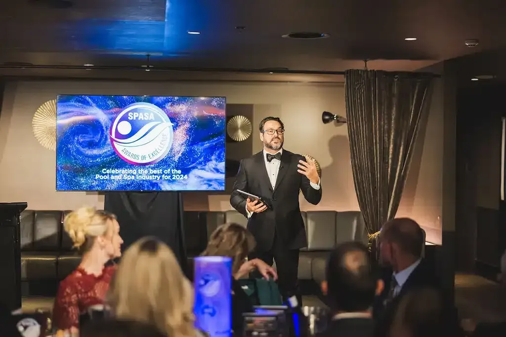 A Man In A Tuxedo Is Giving A Presentation To A Group Of People — Aussie UnderCover In South Nowra, NSW