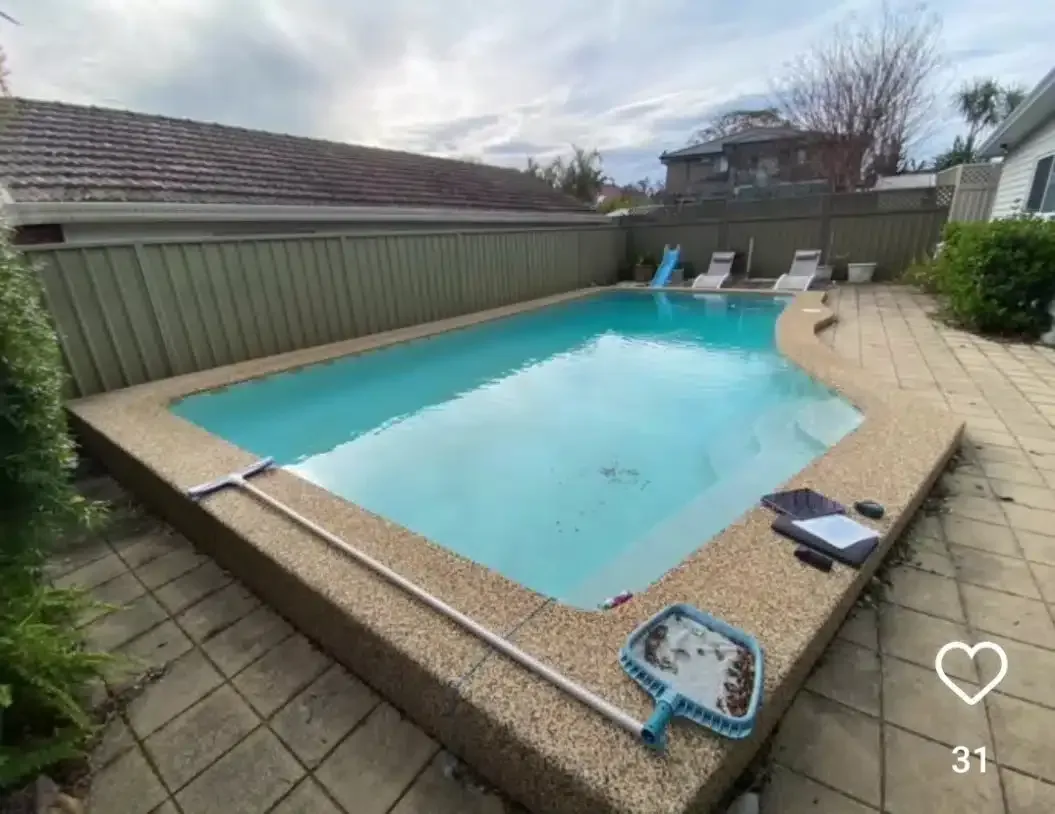 A Large Swimming Pool Is Sitting On A Patio Next To A House — Aussie UnderCover In South Nowra, NSW