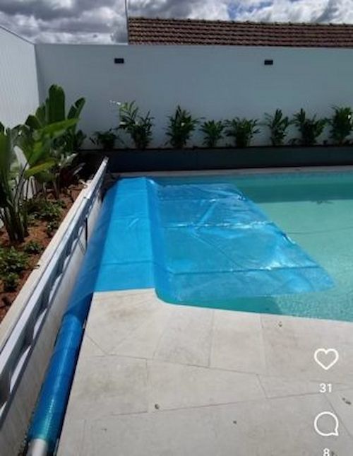 A Swimming Pool With a Blue Cover on It — Aussie UnderCover In South Nowra, NSW
