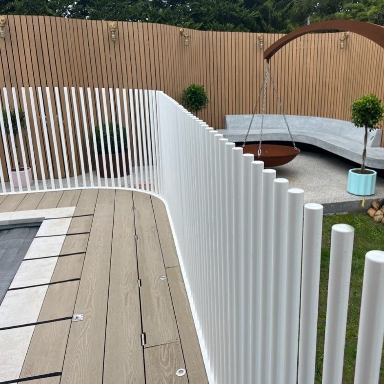 A White Fence Surrounds a Wooden Deck in a Backyard — Aussie UnderCover In South Nowra, NSW