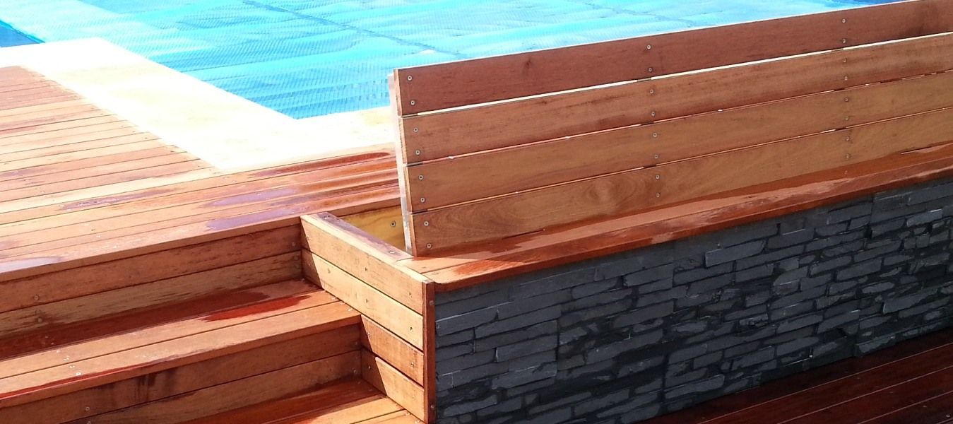 A Wooden Bench Is Sitting Next To A Swimming Pool — Aussie UnderCover In Sunshine Coast, QLD