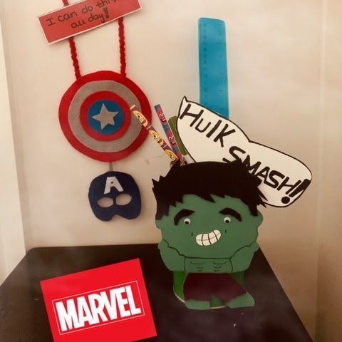 A hulk sitting on a table next to a marvel sign for Dragonfly crafts party